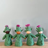 4 felt Burdock Flower Fairies wearing a green dress and a pink flower in the hat with varied skin tones | © Conscious Craft